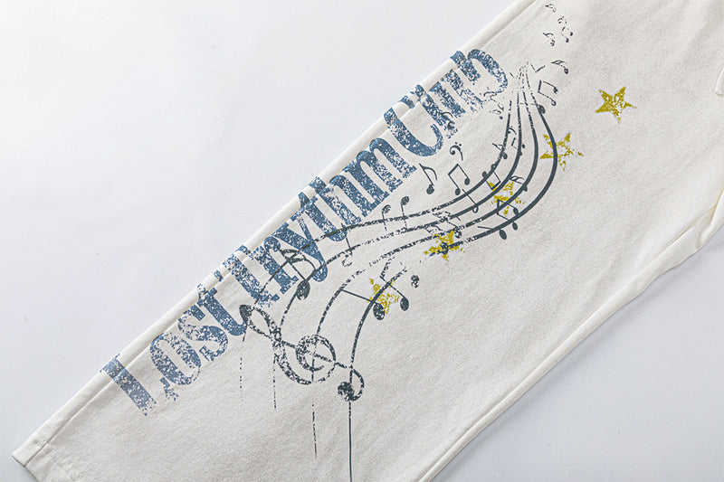 Pantalon de survêtement à jambes larges avec motif de notes de musique, coupe décontractée délavée