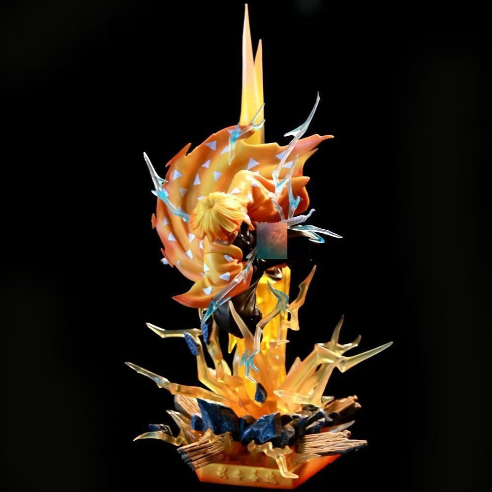 The Rengoku Kyojuro Demon Slayer Flame Hashira Figure showcases a dynamic action pose with orange, yellow, and blue effects against a black backdrop. This 350mm PVC figurine features light-up eyes and base, capturing the character airborne with a focused expression.