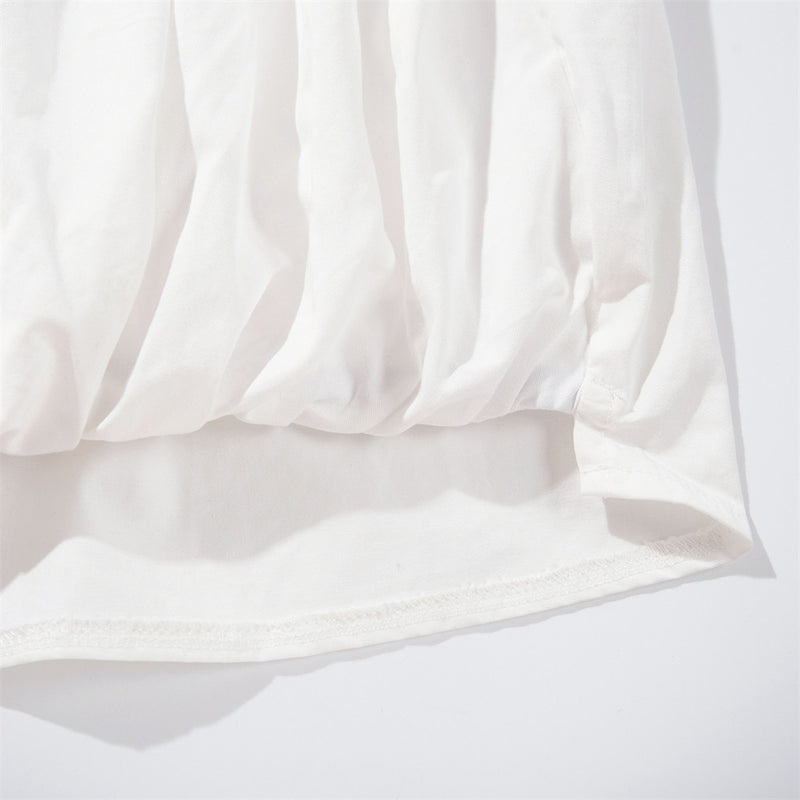 White shirt hem close-up with gathered elastic edge