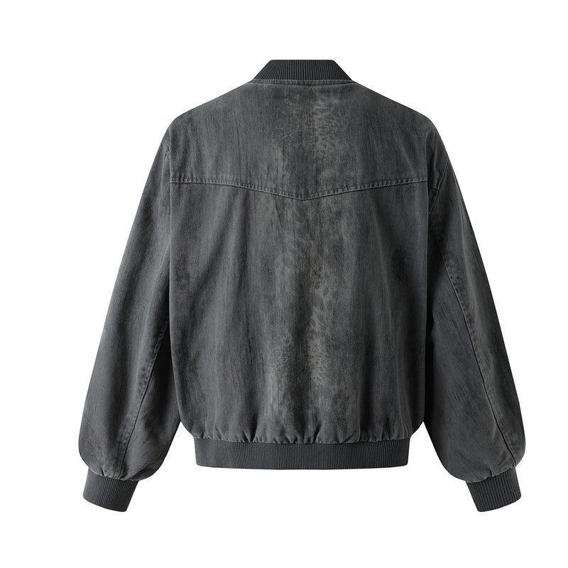Veste bomber en jean délavé déconstruite à empiècement croisé et coutures effilochées