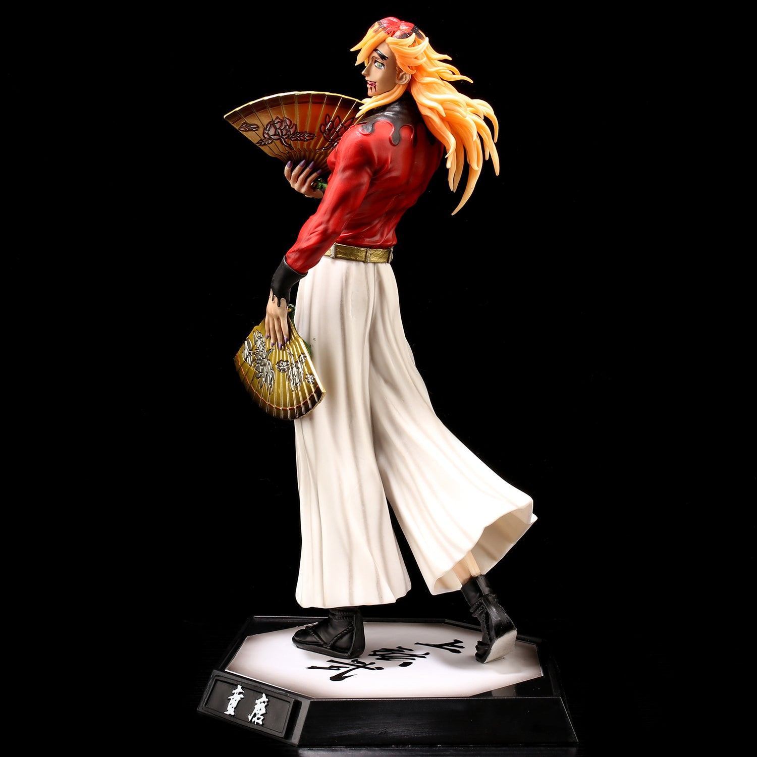 The Tengen Uzui Demon Slayer Figure, a 28CM PVC collectible by Demon Slayer, depicts the character with wavy hair and an ornate fan. Dressed in a red blouse, white pants, and black shoes, it stands on a black and white base with Japanese text.