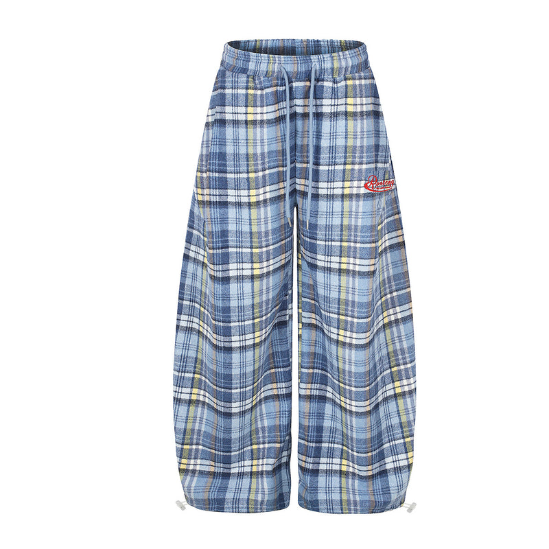 Blue plaid wide-leg flannel pants with drawstring waist and cinched ankle ties, front view