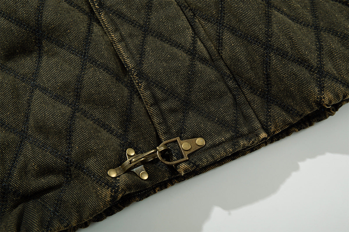 Close-up of the quilted jacket hem showing a metal toggle closure and elasticized edge