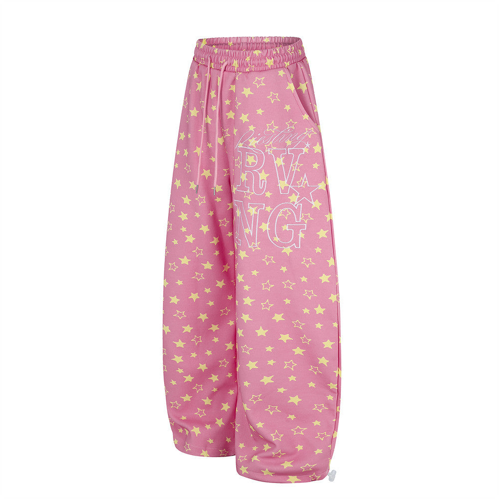 Pink wide leg star print sweatpants, angled side view