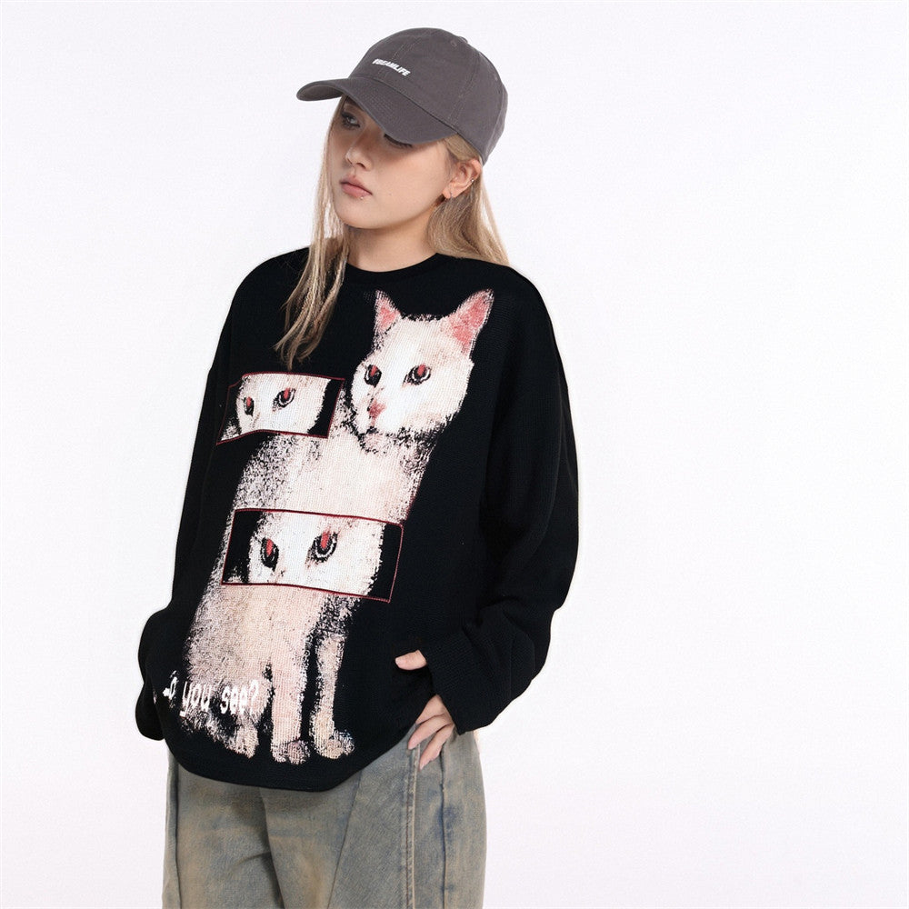 Oversized black waffle-knit long sleeve shirt with white cat graphic print and crew neckline, worn by a female model