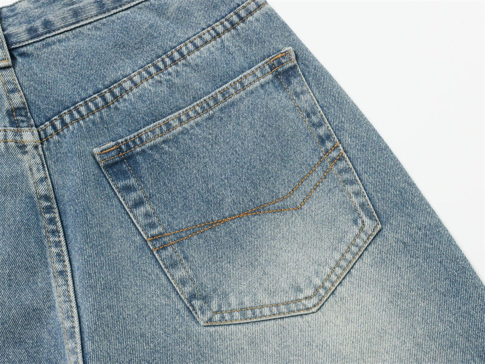 Close-up of light blue jeans back pocket with faded wash and contrast stitching