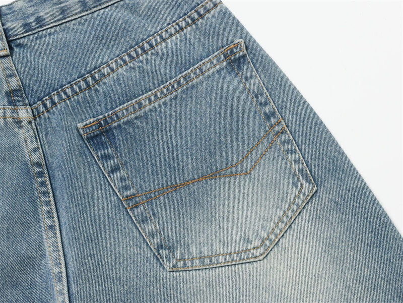 Close-up of light blue jeans back pocket with faded wash and contrast stitching