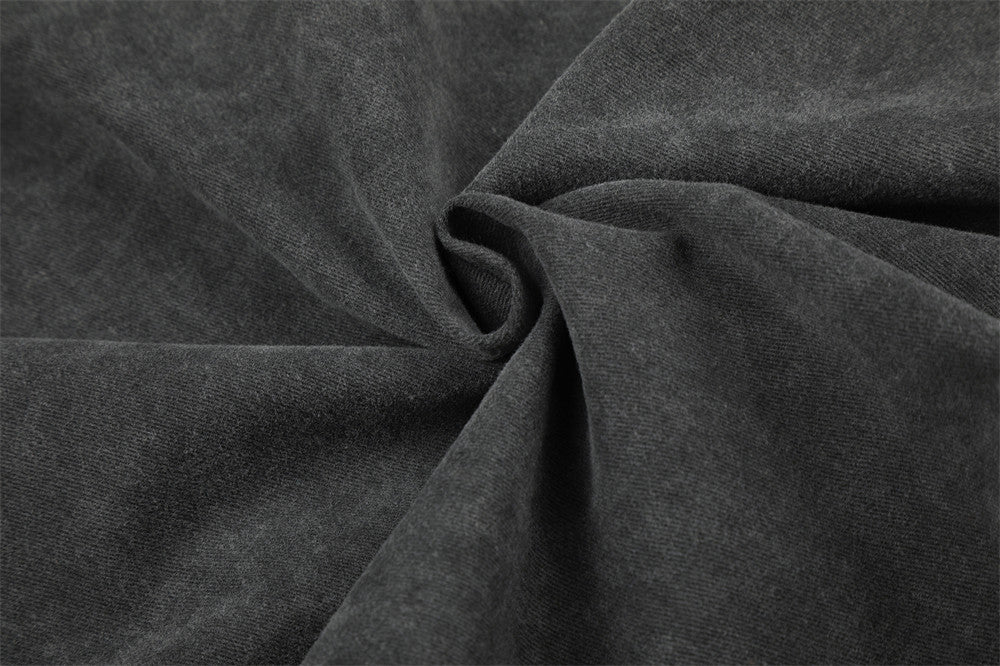 Close-up of dark denim fabric texture with soft folds