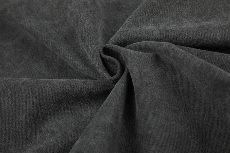 Close-up of dark denim fabric texture with soft folds