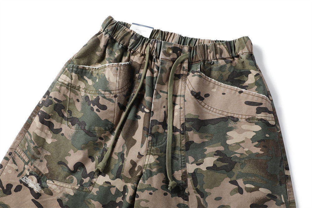 Close-up of camouflage shorts waist, drawstring, and front pockets