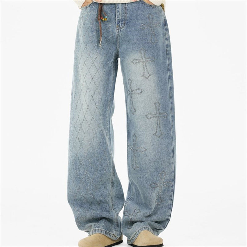 Front view of light blue wide-leg jeans with argyle side panel and cross graphics