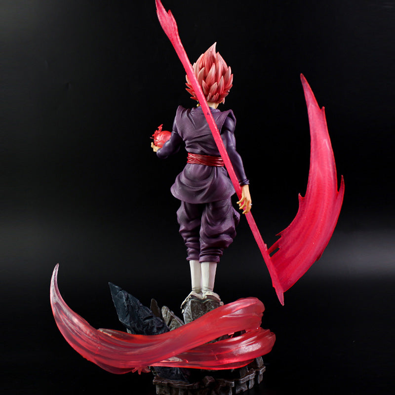 The Seakoff Goku Black Collectible Figure from Dragon Ball Super is a 38cm statue featuring pink spiky hair, purple outfit with white boots, and includes a red staff and sphere surrounded by energy effects. It stands on a black and gray base against a dark background.