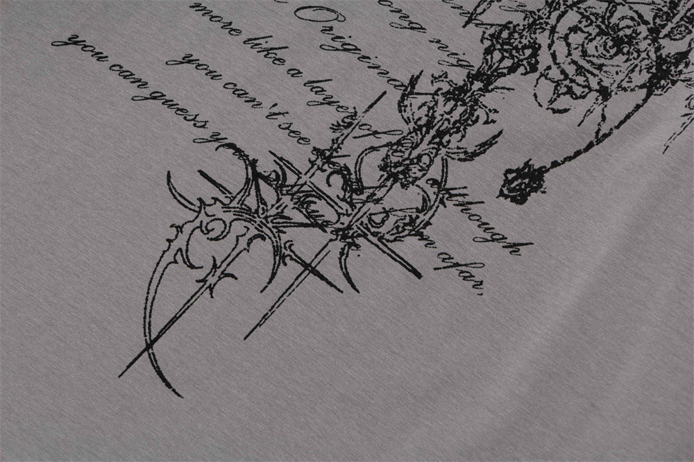 Close-up of gray T-shirt lower front with gothic script and decorative graphic