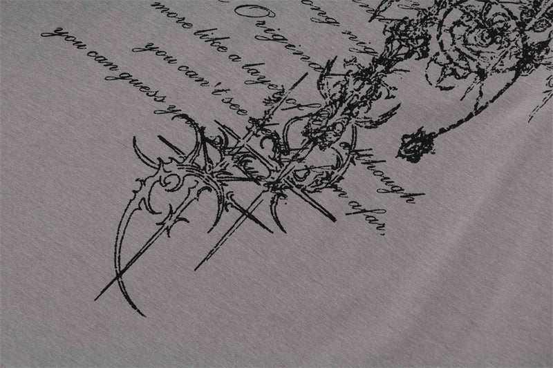Close-up of gray T-shirt lower front with gothic script and decorative graphic