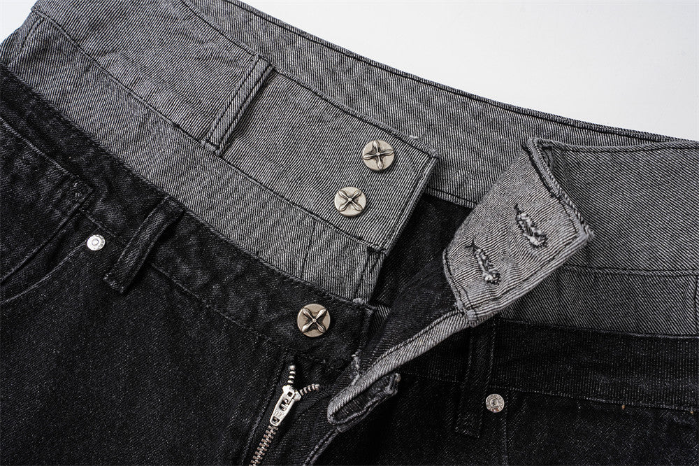 Close-up of layered black and gray waistband with metal buttons and zipper fly
