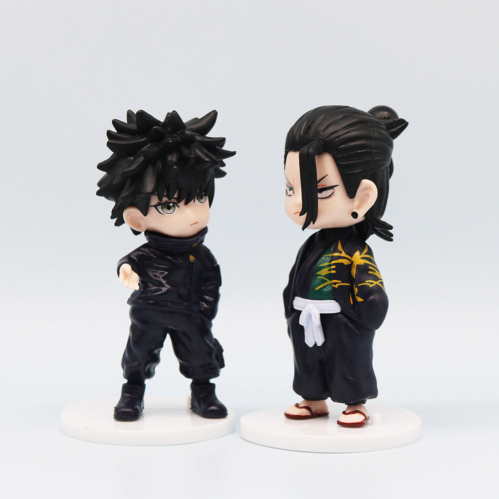 The Jujutsu Kaisen Q Edition Spell Return 7-Piece Set includes two chibi-style PVC figures, each 11 cm tall. One features spiky black hair in a black outfit, and the other has tied-back black hair in a black robe with green and gold accents. Both stand on white bases.