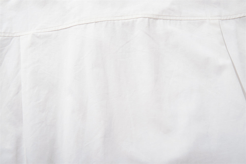 Close-up of white shirt back with top yoke seam