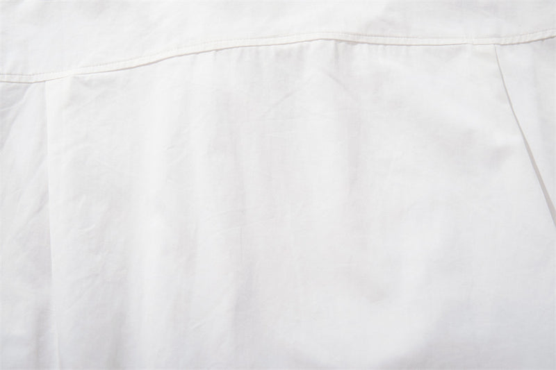 Close-up of white shirt back with top yoke seam
