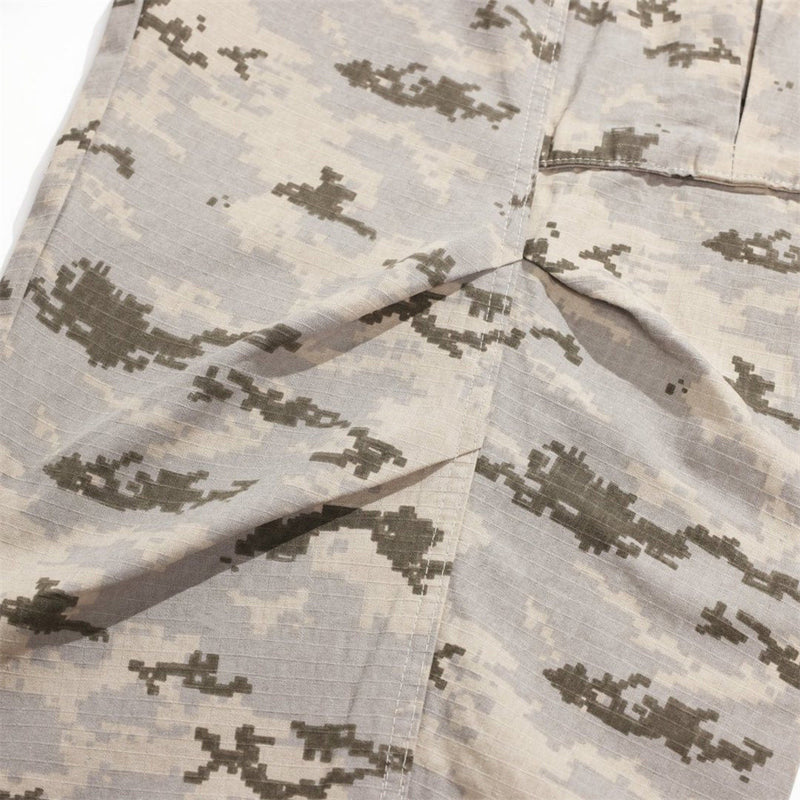 Close-up of front leg seam and pleat on desert camo cargo pants