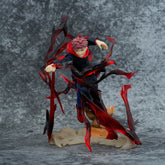 The Jujutsu Kaisen Yuji Itadori PVC Figure stands 18 cm tall, featuring spiky red hair, a dark outfit with red shoes, and dynamic cursed energy effect surrounded by jagged black and red details, set against a textured gray background.