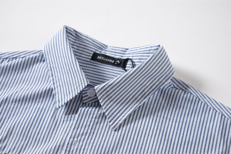 Close-up of the blue striped shirt collar and button placket