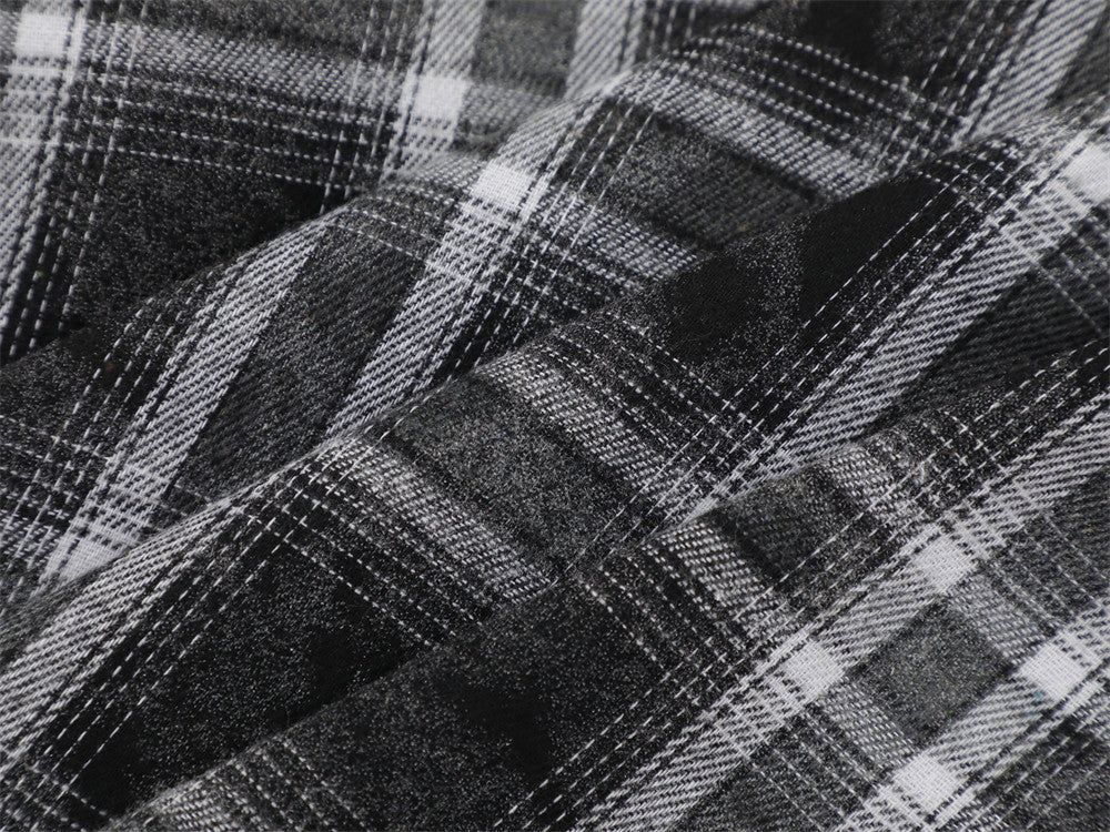 Close-up of black plaid flannel fabric texture and intersecting white stripes