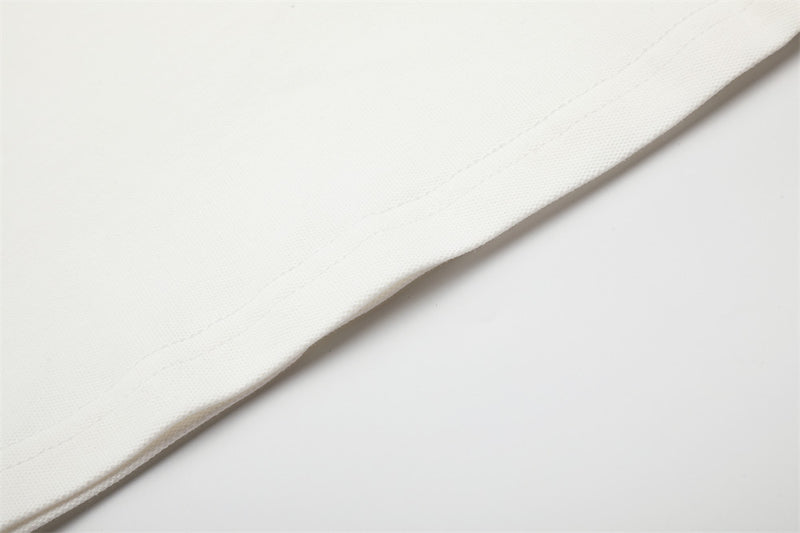 Close-up of white shirt hem seam on smooth knit fabric