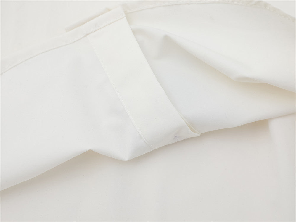 Close-up of white shirt sleeve cuff and seam detail