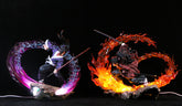 The Kokushibo Demon Slayer Figure, a premium 30cm PVC statue, features him in an action pose with glowing purple water-like swirls, while his companion showcases fiery red flames. Both stand on rocky bases against a black background.