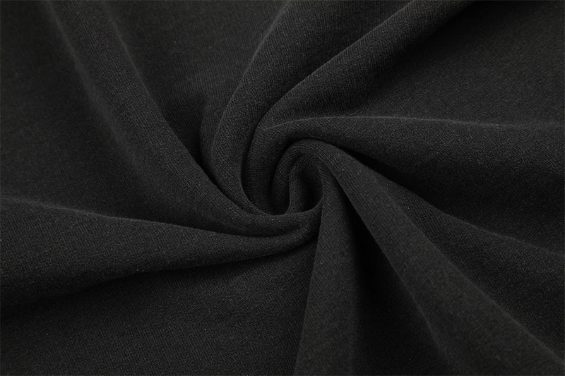 Close-up of black fabric texture gathered into a swirl