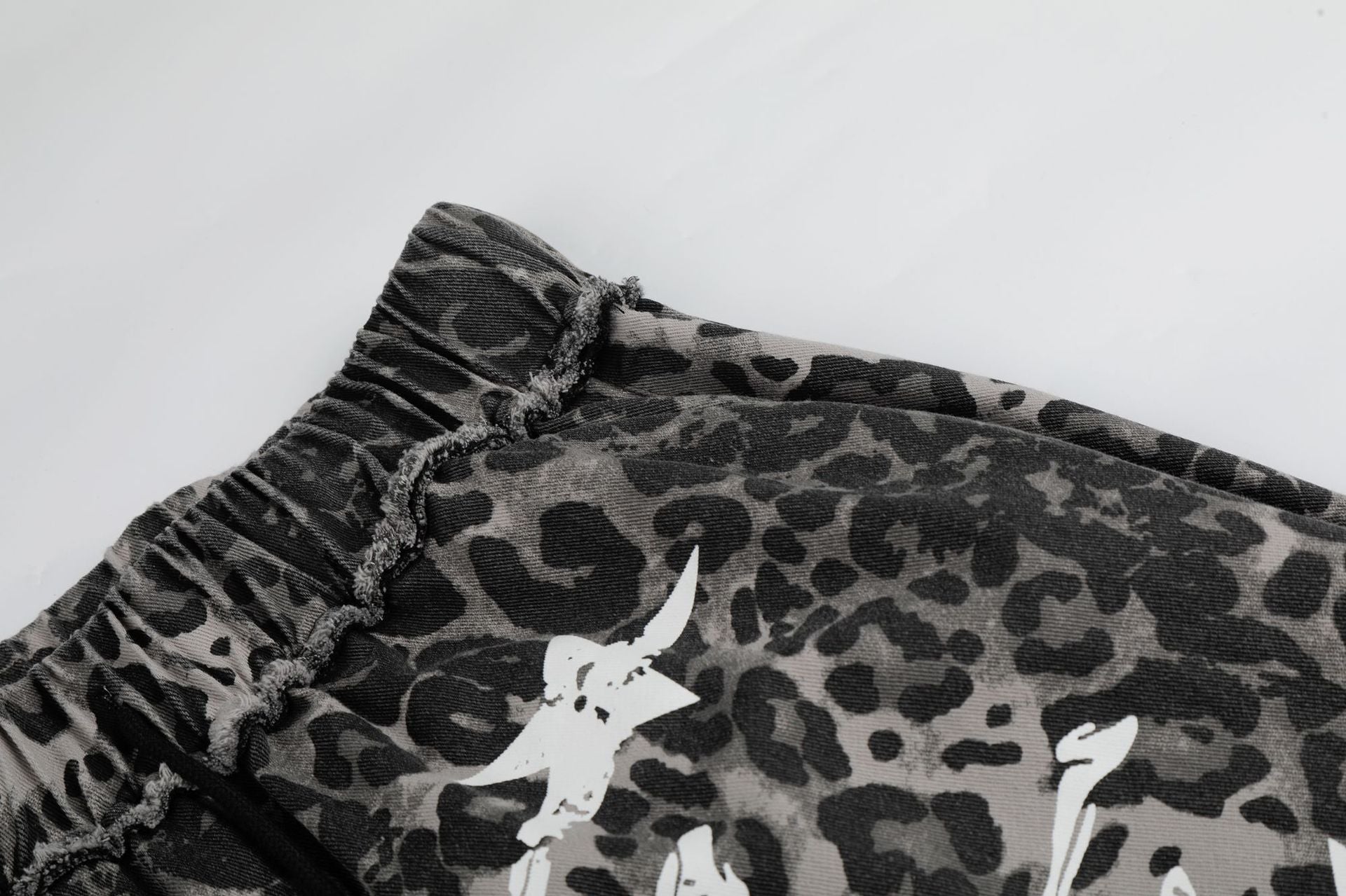 Wide-Leg Leopard Print Pants with Skull & Crossbones Graphic