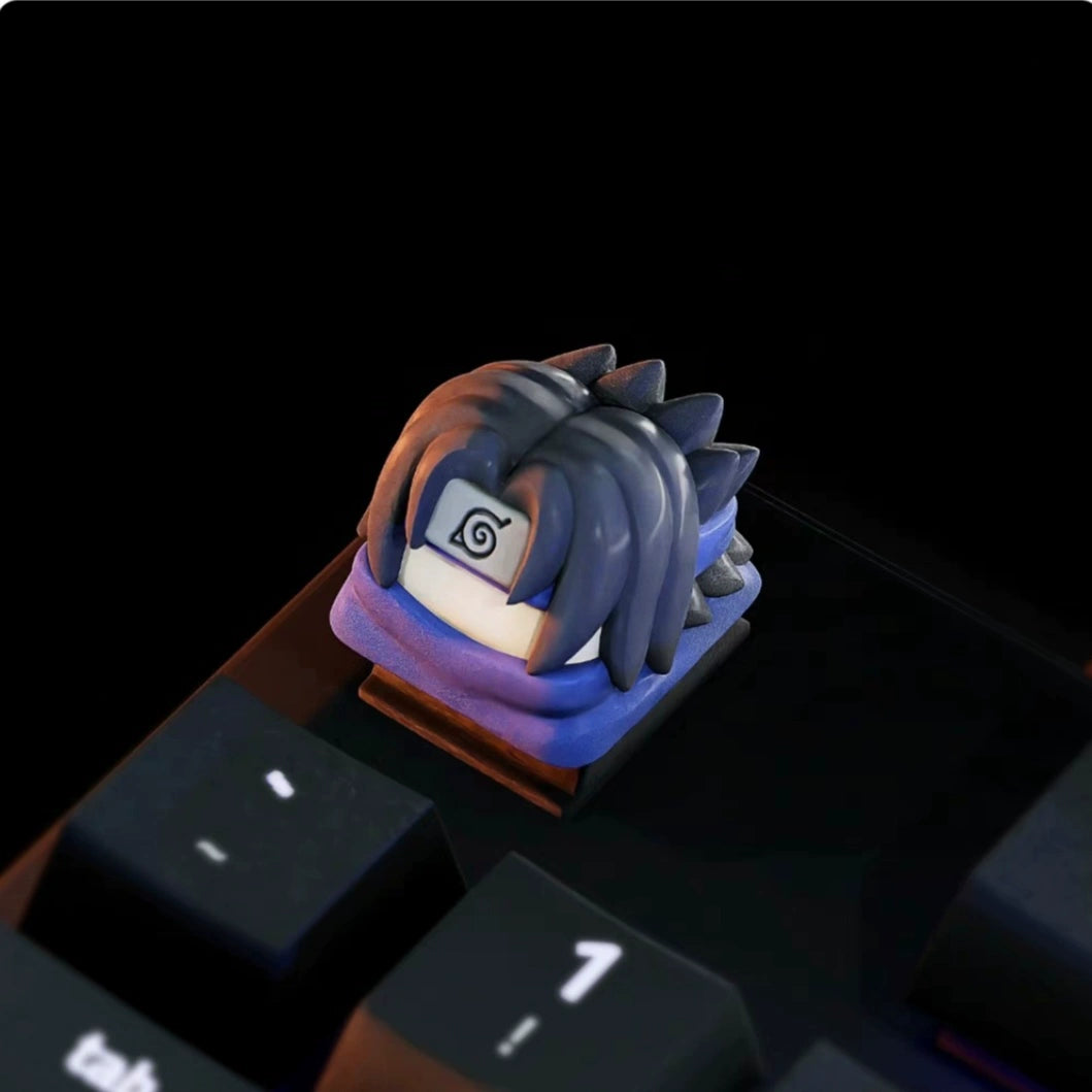 Close-up of a Naruto keycap from the Naruto Keycaps Set by Naruto on the &quot;1&quot; key, showcasing a styled character with dark spiky hair and a forehead emblem, perfect for anime fans.