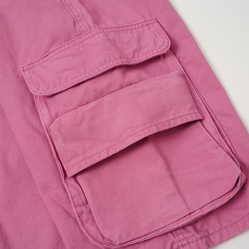 Close-up of side cargo pocket flap on rose pink shorts