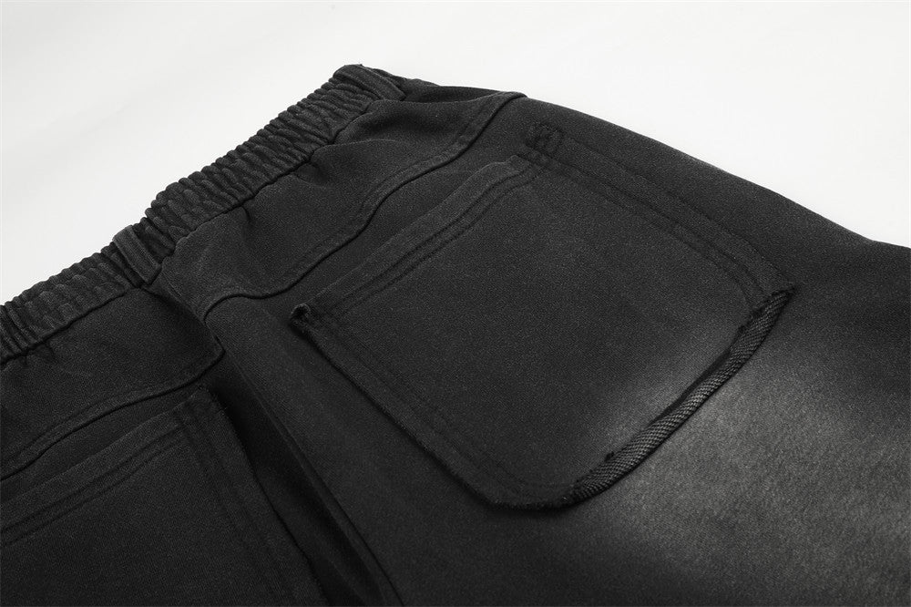Pantalon de survêtement ample à œillets métalliques, finition délavée à l’acide & ourlet brut