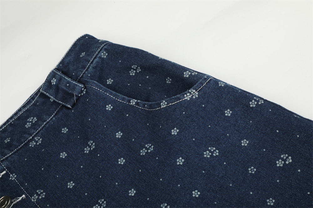 Close-up of dark blue denim upper back panel with small floral print and top waistband