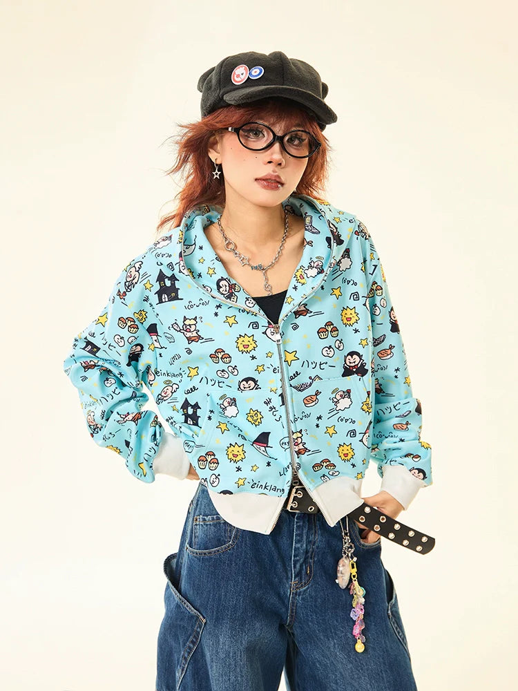 Wearing a black cap with badges, glasses, and a playful streetwear ensemble, the person confidently sports Seakoff's Kawaii Cartoon Bear Hoodie—a cute full-zip hoodie with adorable ears and fun cartoon print. Their wide-legged jeans feature a decorative belt and chain accessories.