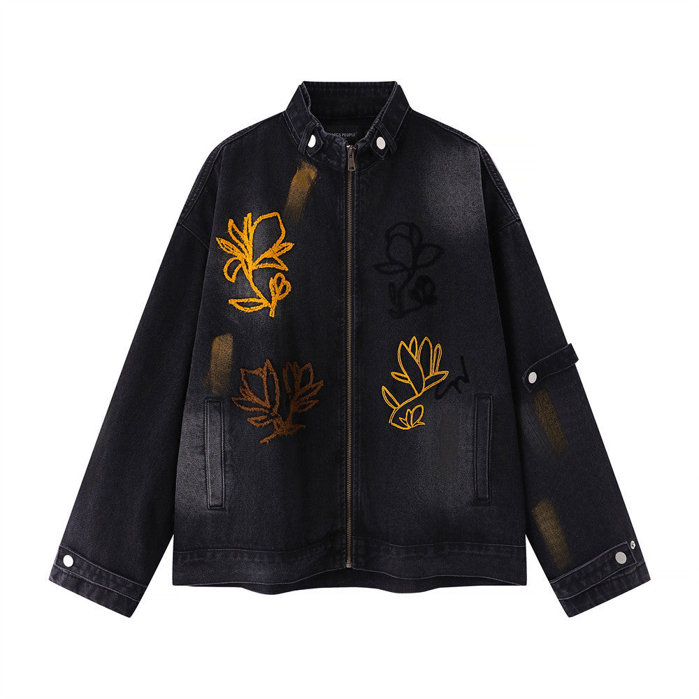 Oversized washed black denim jacket with multi-color floral chain-stitch embroidery and brushstroke paint accents, front view