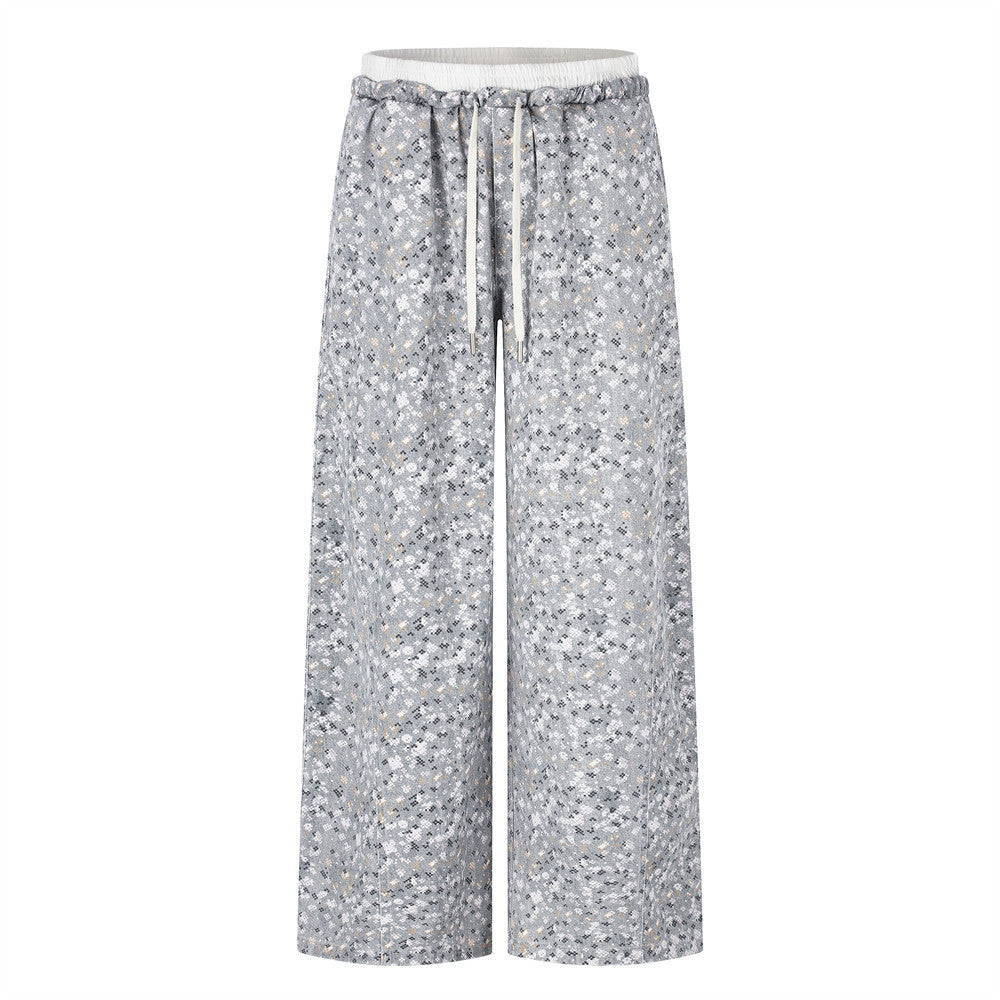 Front view of wide-leg gray floral print pants with elastic waistband and drawstring
