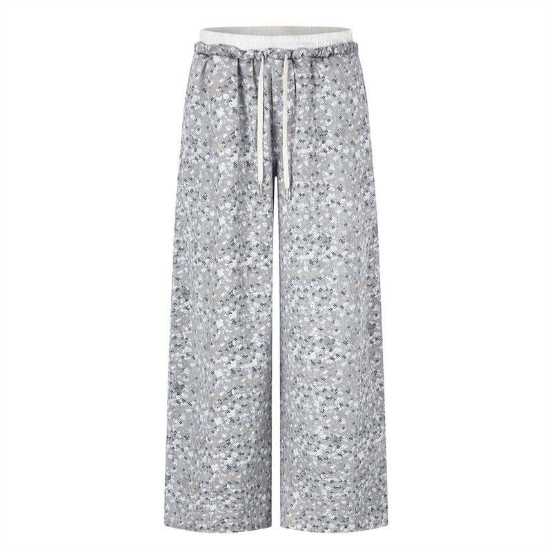 Front view of wide-leg gray floral print pants with elastic waistband and drawstring
