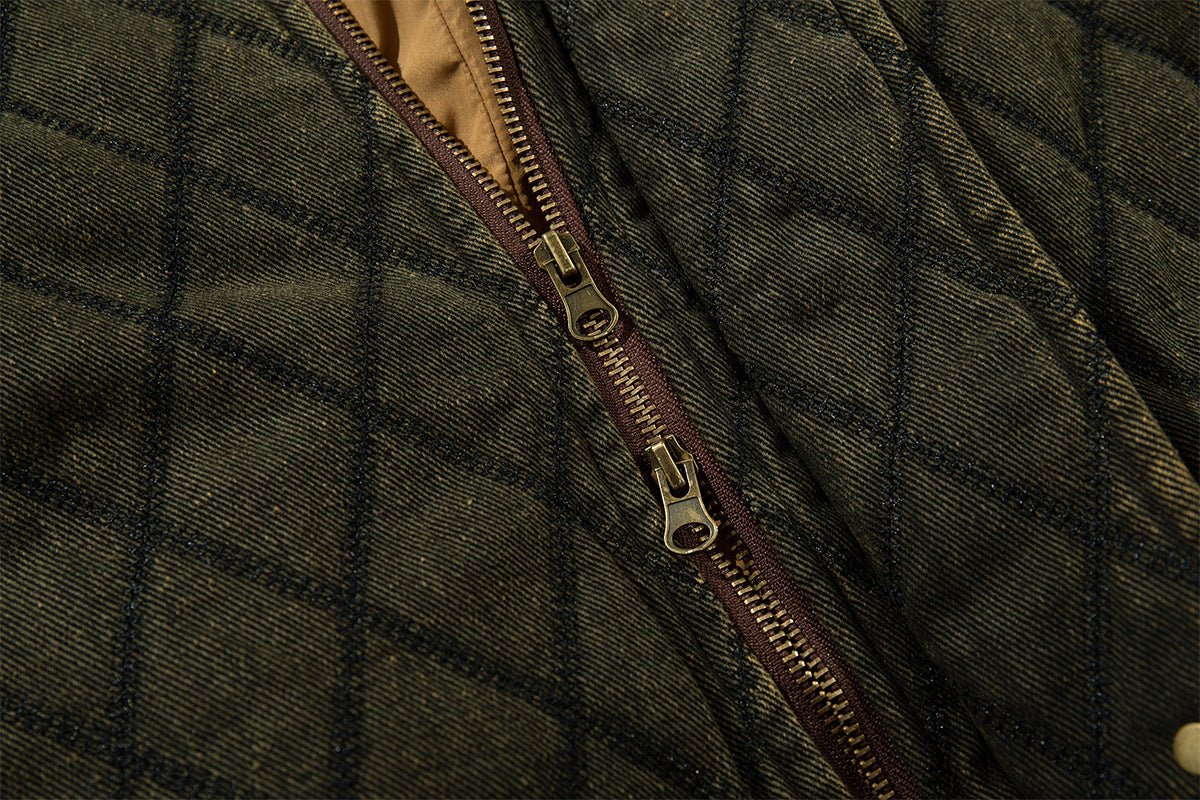 Close-up of the olive quilted jacket front zipper with a brown zipper tape and metal pull