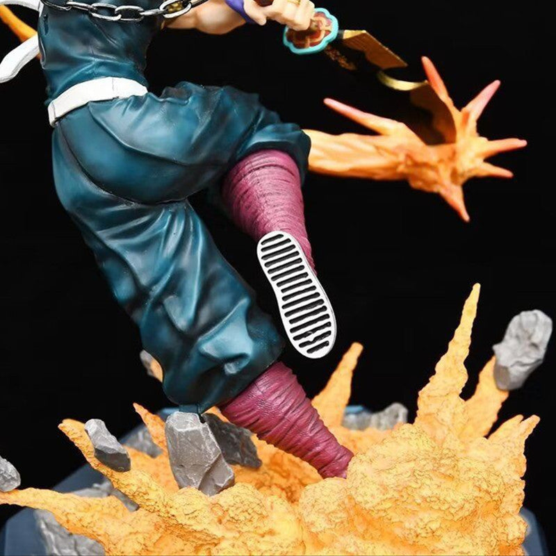 A dynamic close-up of the Premium Demon Slayer Urogi Figure from Demon Slayer, a 37cm high-quality GK model. Featuring anime-style details, a key-like sword, USB light-up effects with orange flames and rocks underfoot, set against a plain black background to emphasize its dramatic pose.