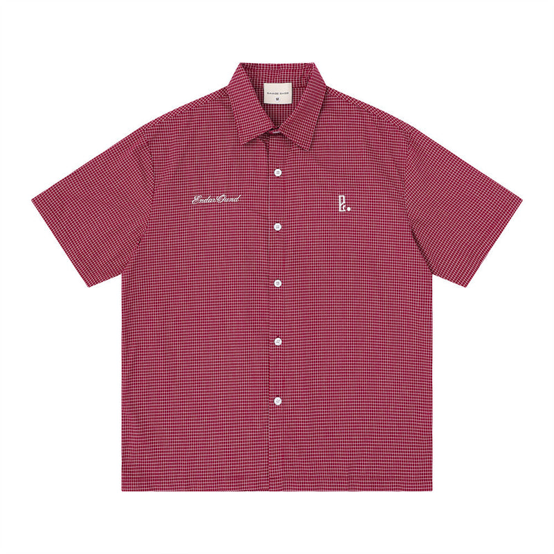 Oversized American casual plaid short sleeve shirt with white script embroidery on chest and back, shown in red colorway