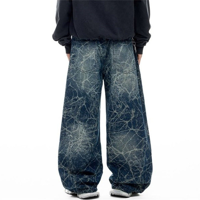 Back view of wide-leg distressed blue jeans with faded constellation print