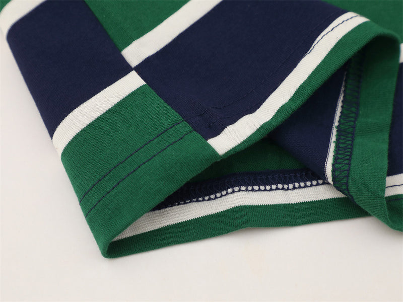 Close-up of hem and sleeve stitching on green and navy striped polo shirt