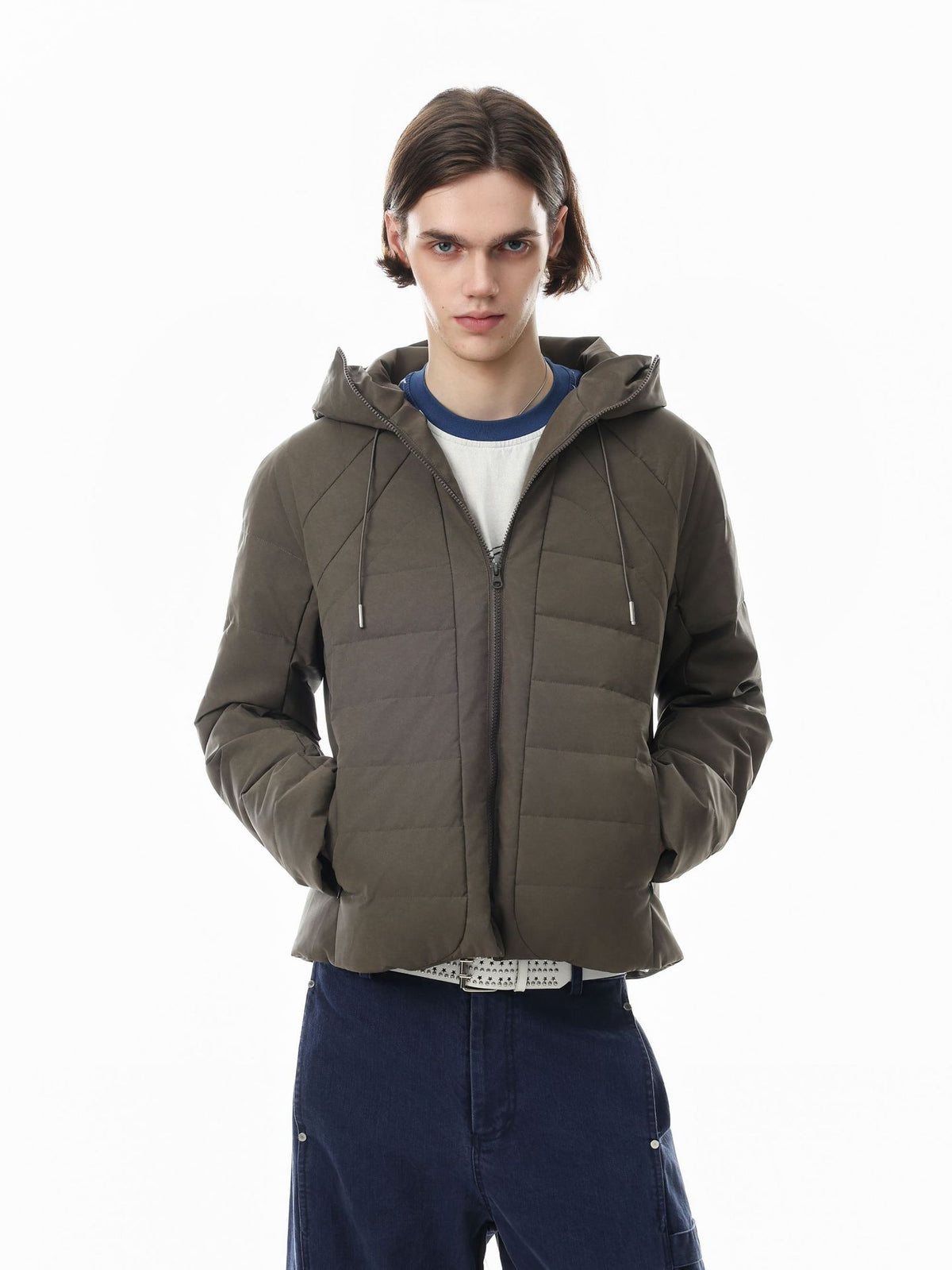 Hooded quilted puffer jacket with ribbed front panel and drawstring hood in olive khaki, worn by male model