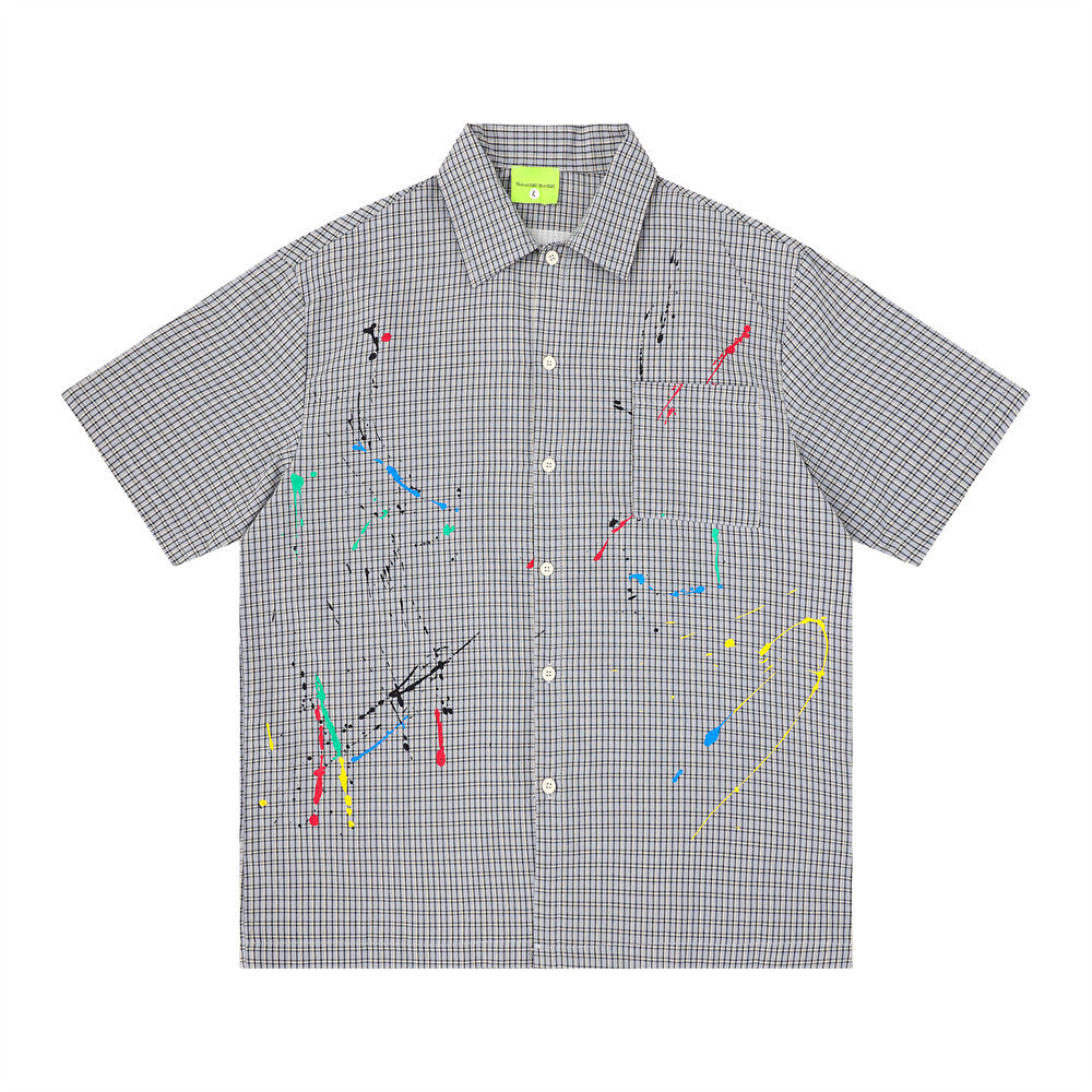 Front view of gray plaid short sleeve button-up shirt with chest pocket and multicolor paint splatter