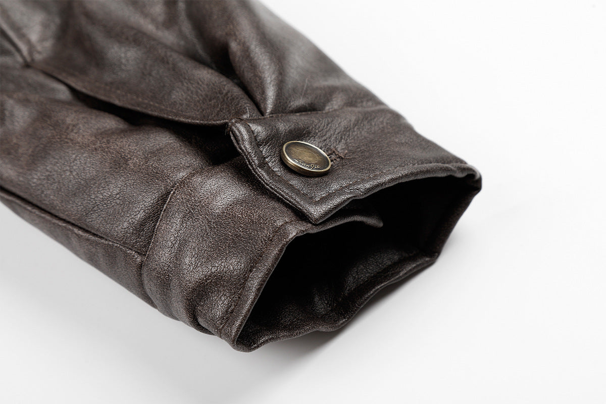 Close-up of a brown faux leather cuff with snap tab and ribbed sleeve opening