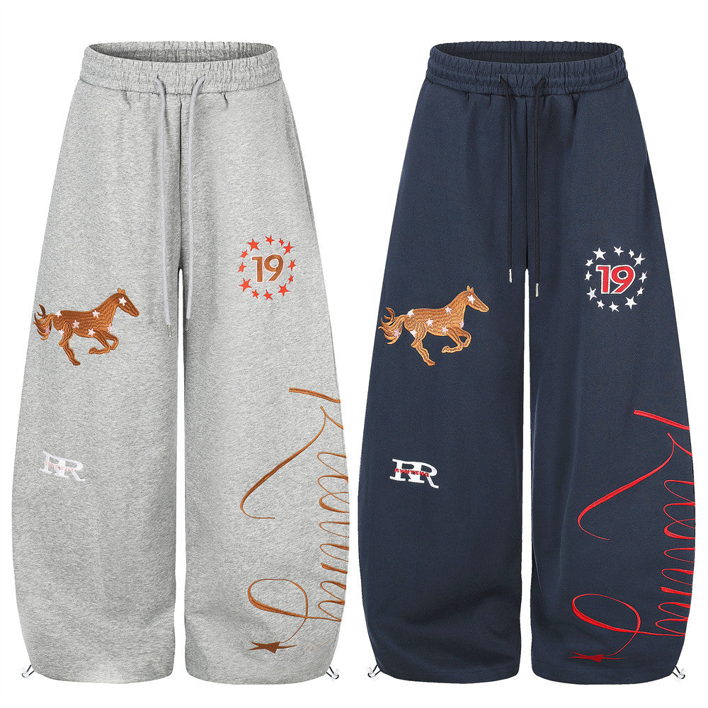 Wide-leg sweatpants shown in gray and navy with horse embroidery, star 19 graphic, and script print
