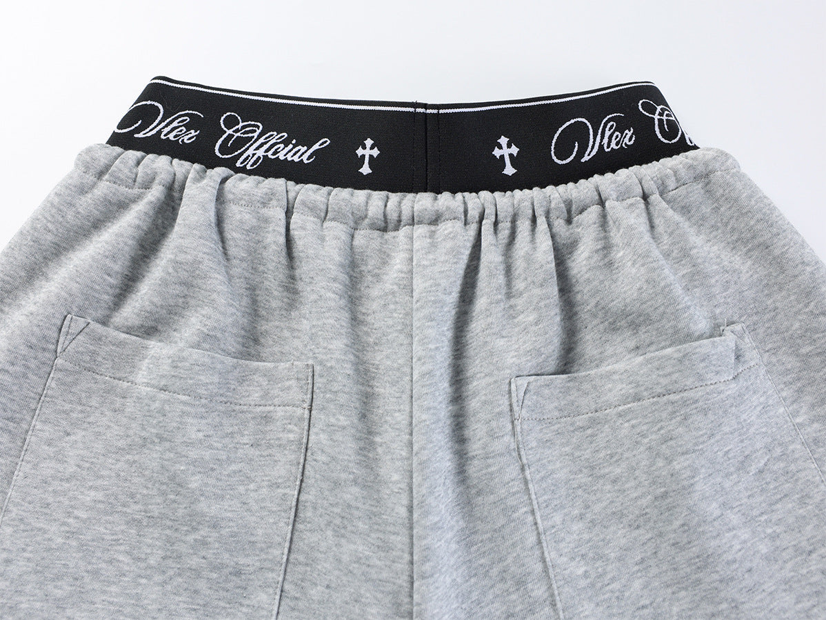 Pantalon de survêtement à jambes larges avec imprimé graffiti cursif et ceinture élastiquée siglée