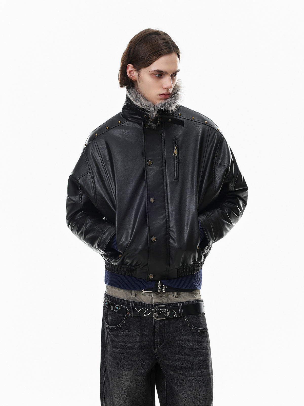 Model wearing a black faux leather bomber jacket from a side-front view with raised collar
